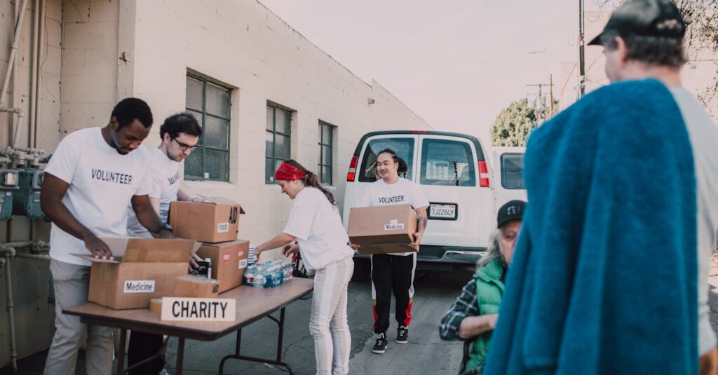 Group of volunteers organizing donations outside, showcasing diversity and teamwork.
